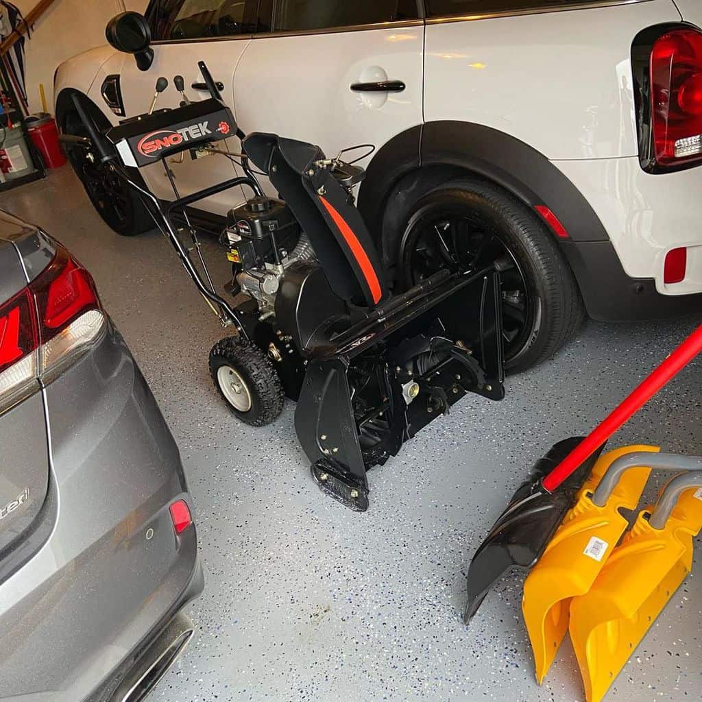 ARIENS Sno-Tek snow blower stands in the garage