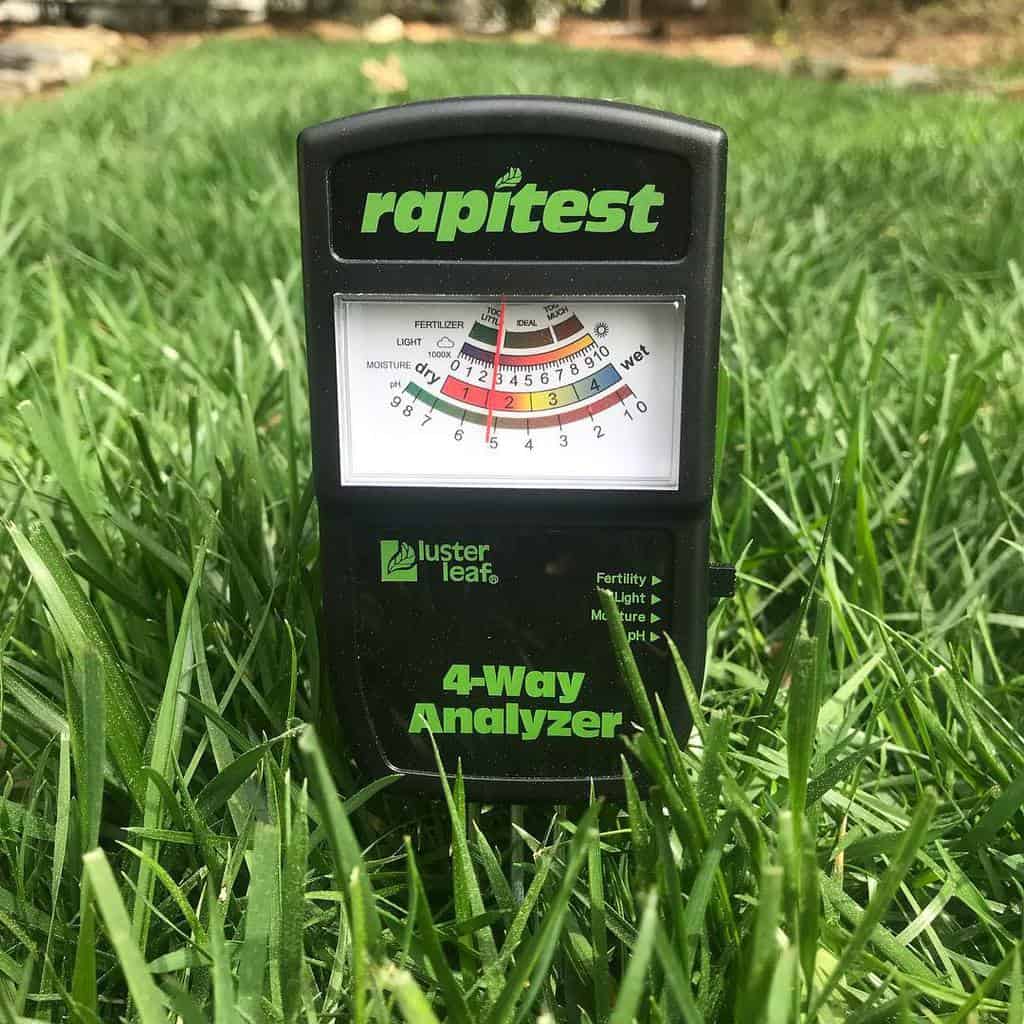 In the ground is the Luster Leaf Rapitest Tester Electronic 4-Way Analyzer, Soil