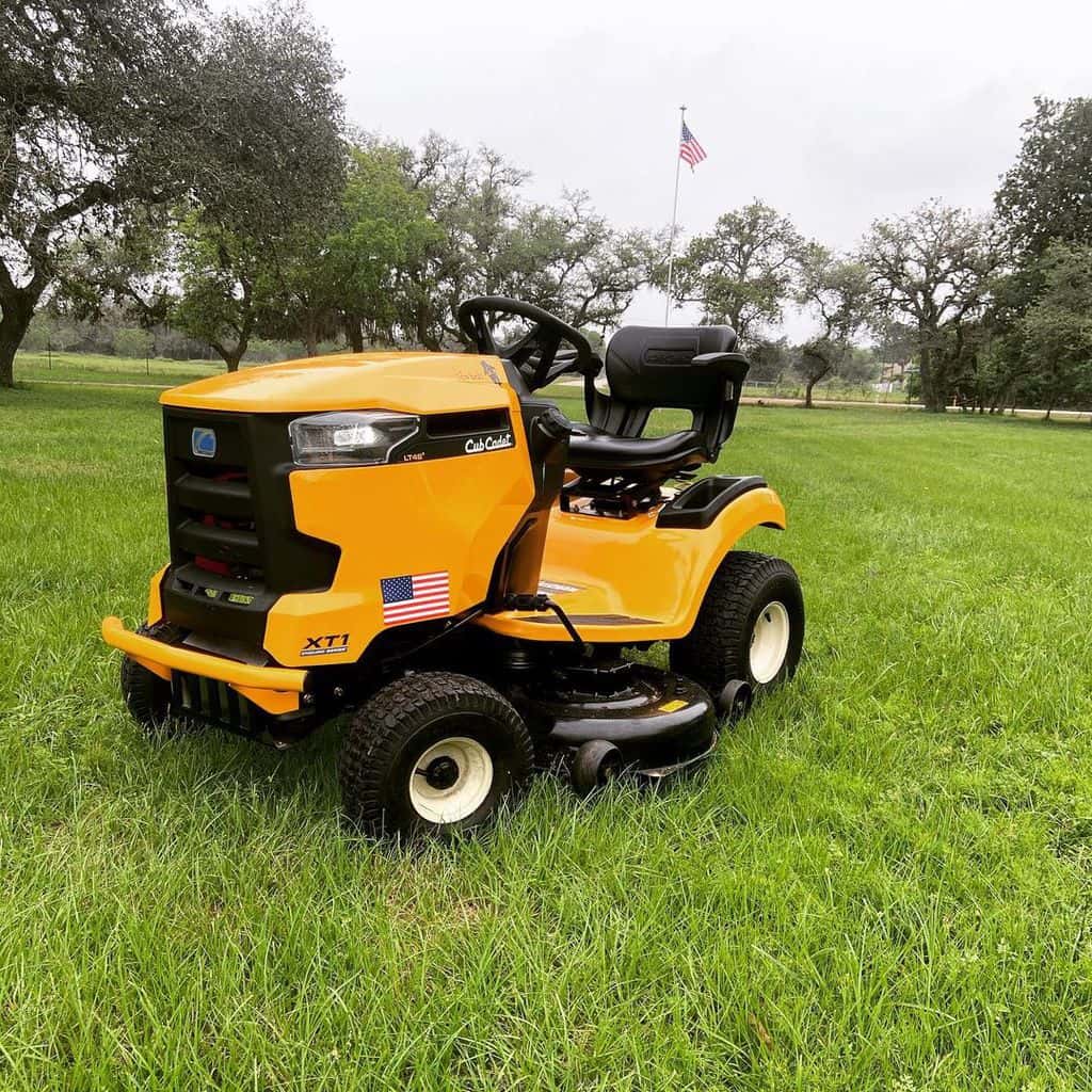 On the grass stands a Cub Cadet Enduro Series Kohler Hydrostatic Gas Front-Engine Riding Mower