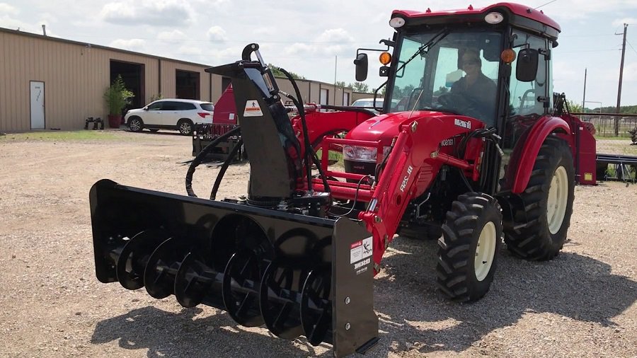 On the ground is a NorTrac Snow Blower - 60in.W Intake, fits Tractors