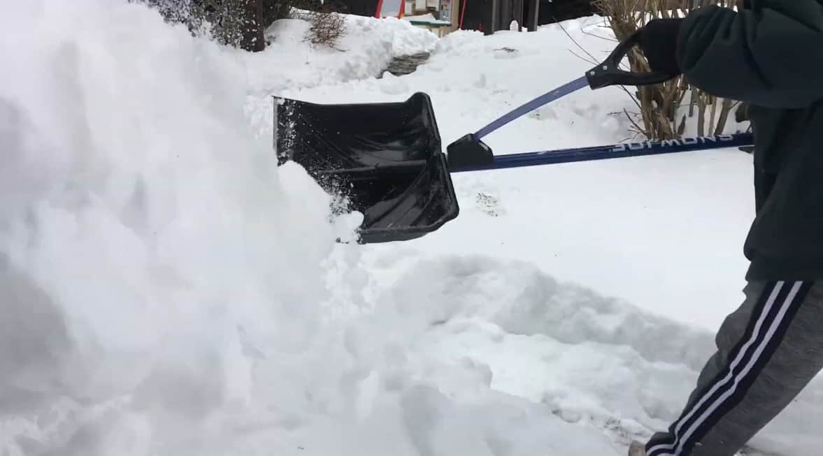 Man shovels snow with Snow Joe Shovelution