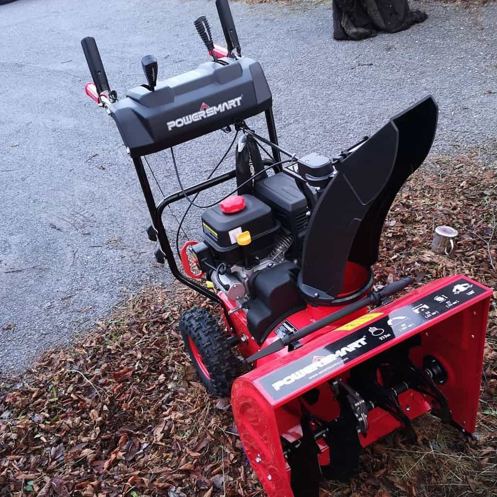 On the leaves is a Powersmart 22 In. 2-Stage Snow Blower