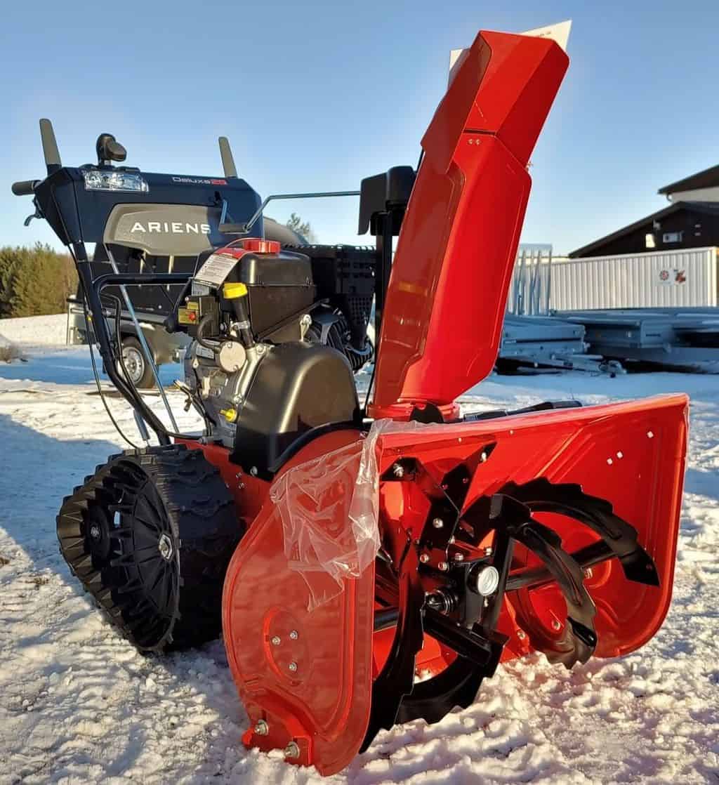 Ariens 2-Stage Gas Snow Blower stands in the snow