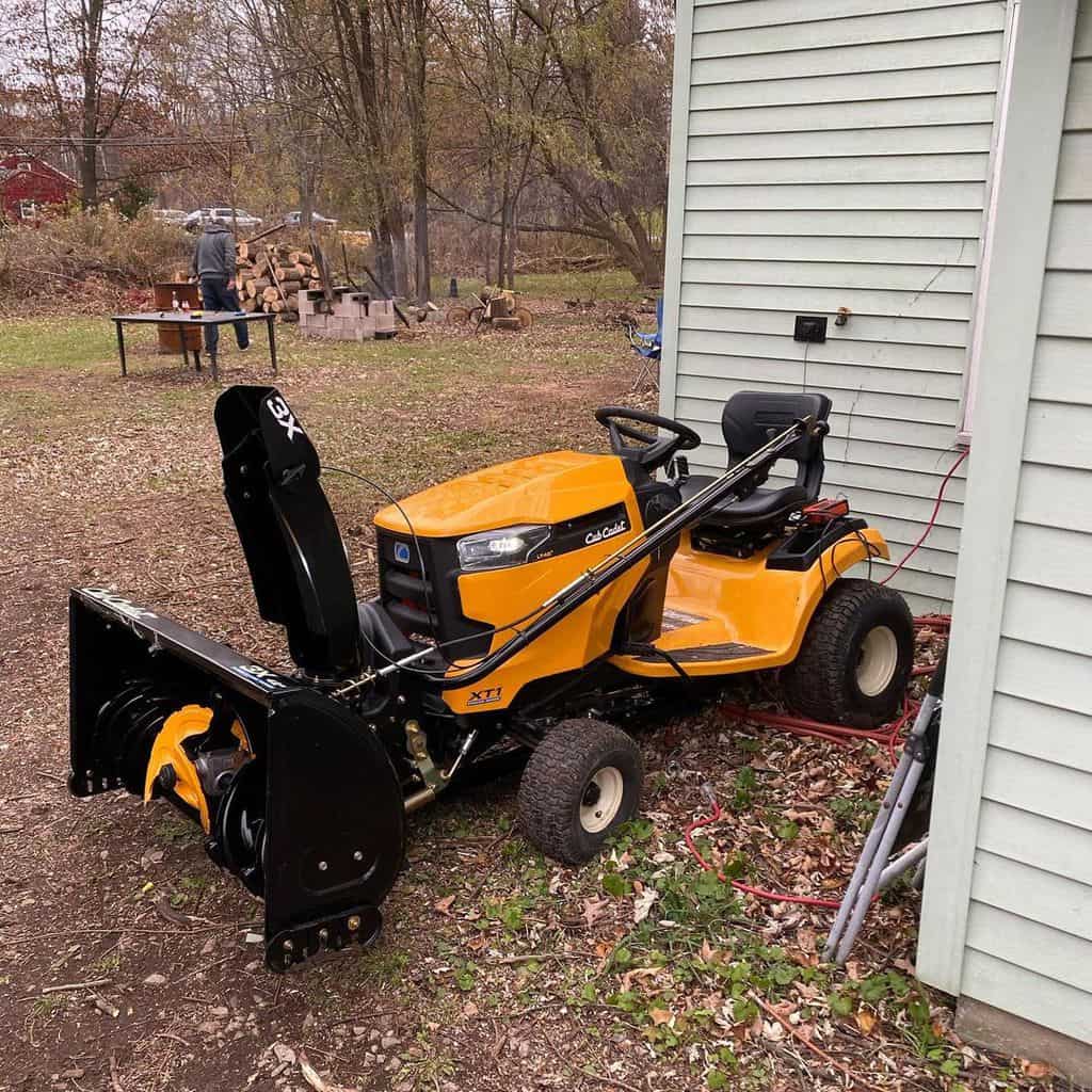There is a Cub Cadet 3x Hydrostatic 3-Stage Snow Blower in front of the house