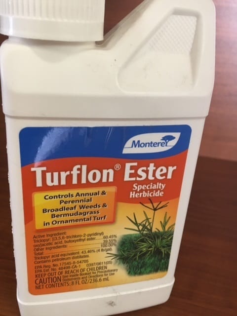 There is a Monterey Turflon Ester 16oz on the table