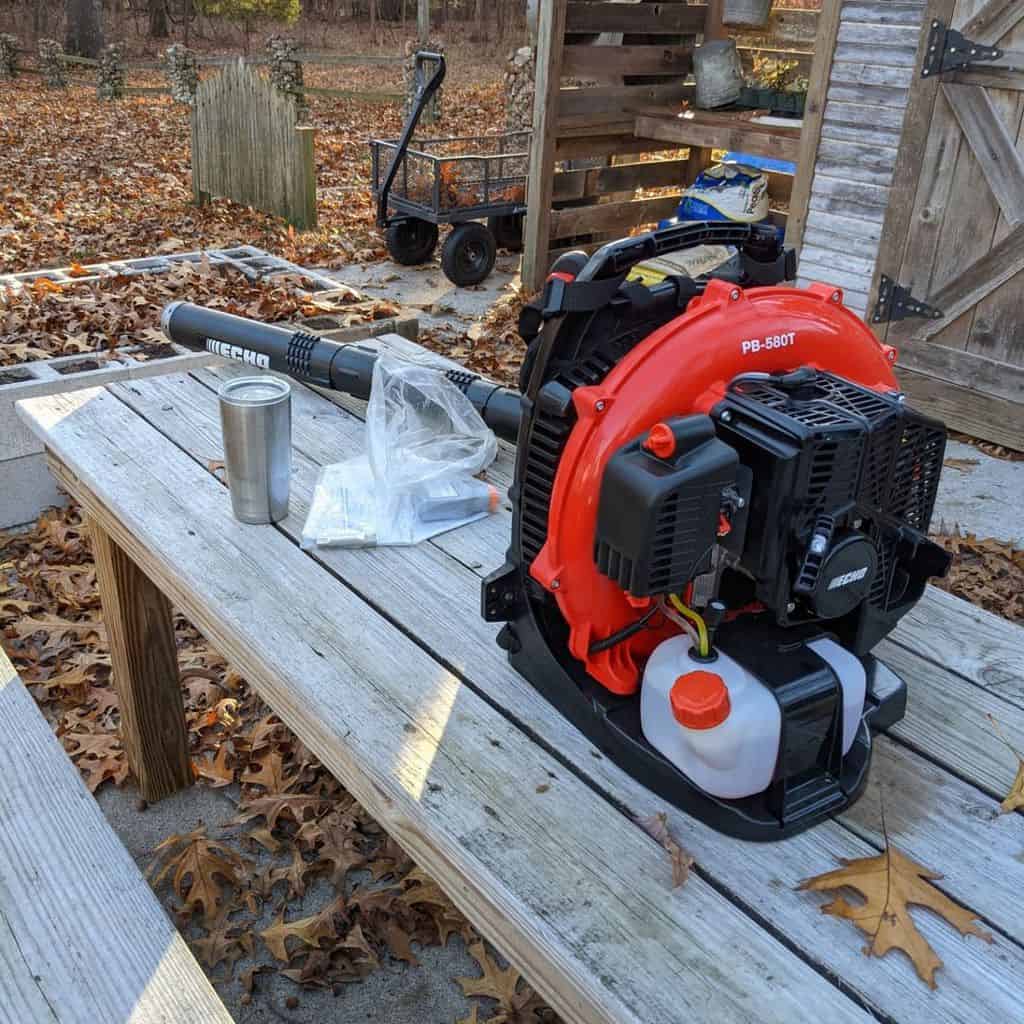 On the bench is an Echo Handheld Gas Leaf Blower