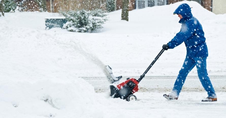 Man removing snow with a snow blower