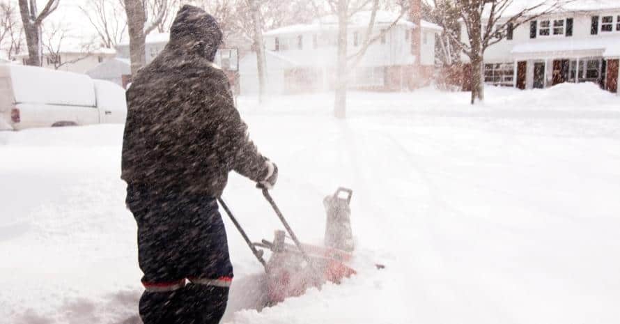 Man shoveling snow during a snowfall