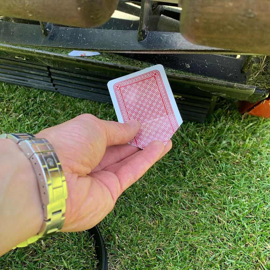 man sticking LawnMaster card