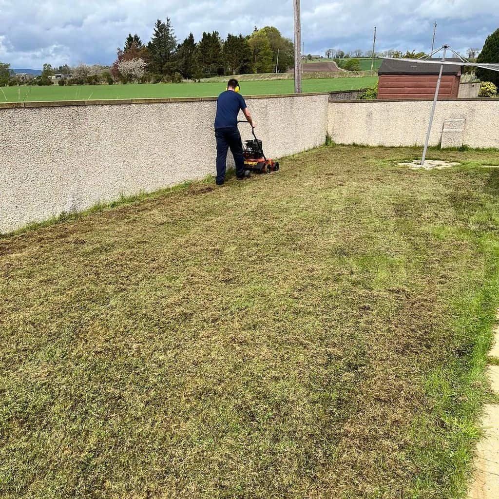 man with LawnMaster near the fence