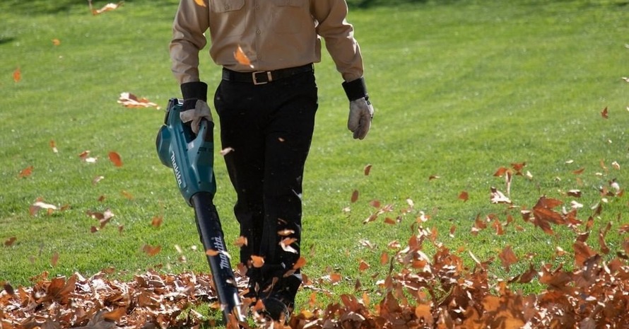 Man Are Brining Handheld Leaf Blower